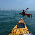 Paddling through calm waters of Cartagena Bay with a view of the city skyline - Juan Ballena